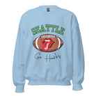 Support the Seattle Seahawks in style with this unique sweatshirt featuring a football and playful lips and tongue design. Featuring the team's slogan "Go Hawks" and the iconic Seattle wordmark, on a light blue sweatshirt. 