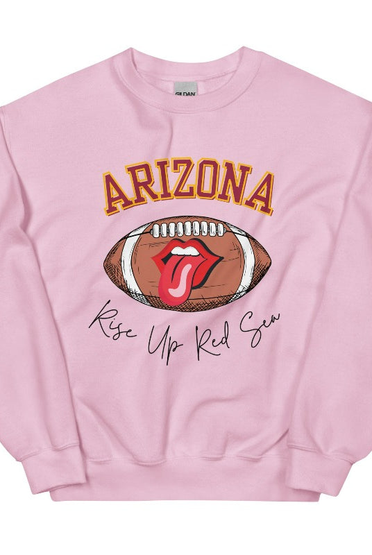 Support the Arizona Cardinals in style with our exclusive sweatshirt featuring the team's name and rallying slogan, "Rise Up Red Sea." On a light pink sweatshirt. 