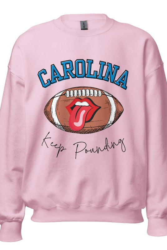 Support the Carolina Panthers in style with our modern and trendy sweatshirt featuring the team's name and powerful teams slogan, "Keep Pounding." On a pink sweatshirt. 