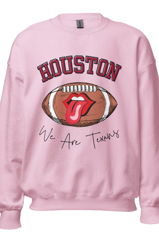 Embrace your Houston Texans pride with our exclusive sweatshirt. It features the team's name and an empowering slogan, "We Are Texans." On a pink sweatshirt. 