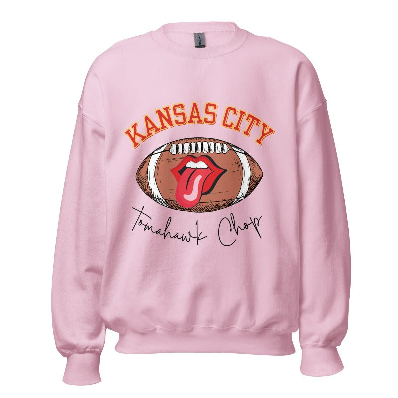 Show off your Kansas City pride with our exclusive sweatshirt that features the team's name and the spirited slogan, "Tomahawk Chop." On a pink sweatshirt. 