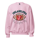 Show your support for the Philadelphia Eagles with this stylish sweatshirt, featuring a football and fun lips and tongue design. Complete with the team's iconic slogan "Fly Eagles Fly" and the distinctive Philadelphia wordmark, on a pink sweatshirt. 