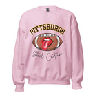 Geer up for game day with this Pittsburgh Steelers sweatshirt, featuring a football and playful lips and tongue design. Emblazoned with the team's iconic slogan "Steel Curtain" and the distinctive Pittsburgh wordmark, on a light pink sweatshirt. 