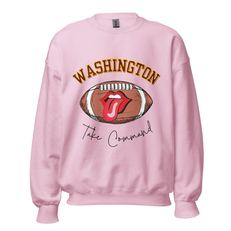 Show your support for the Washington Commanders with this stylish sweatshirt, featuring a football and fun lips and tongue design. Complete with the team's slogan "Take Command" and the distinctive Washington wordmark, on a light pink sweatshirt. 