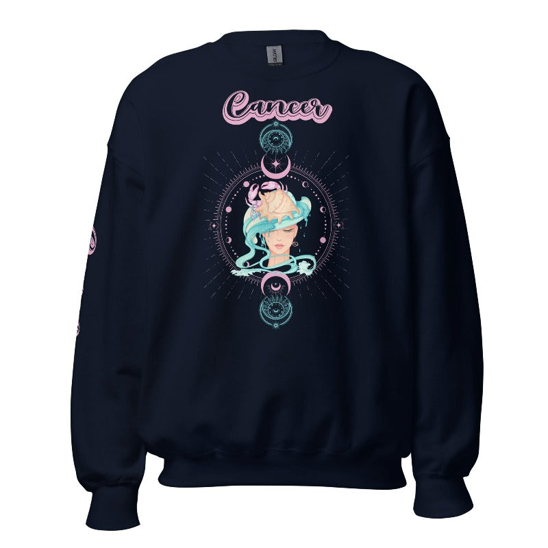 Navy Gildan sweatshirt featuring a vibrant Cancer zodiac design. The front showcases an artistic representation of a woman with flowing hair adorned with a crab, surrounded by celestial elements like moons and stars, in pastel colors. The word "Cancer" is written in a stylish pink script above the design. The sleeve also has "Cancer" written vertically in matching pink script.