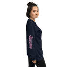 Navy Gildan sweatshirt featuring a vibrant Cancer zodiac design. The front showcases an artistic representation of a woman with flowing hair adorned with a crab, surrounded by celestial elements like moons and stars, in pastel colors. The word "Cancer" is written in a stylish pink script above the design. The sleeve also has "Cancer" written vertically in matching pink script.