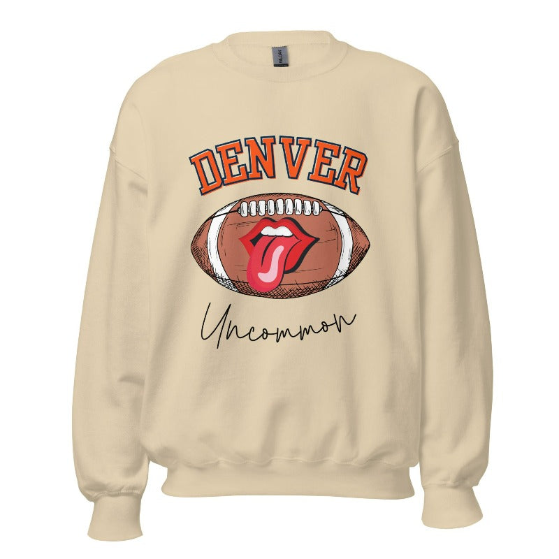 Get ready to show your support for the Denver Broncos in style with our exclusive sweatshirt featuring the team's iconic name and their slogan "uncommon." On a sand colored sweatshirt. 