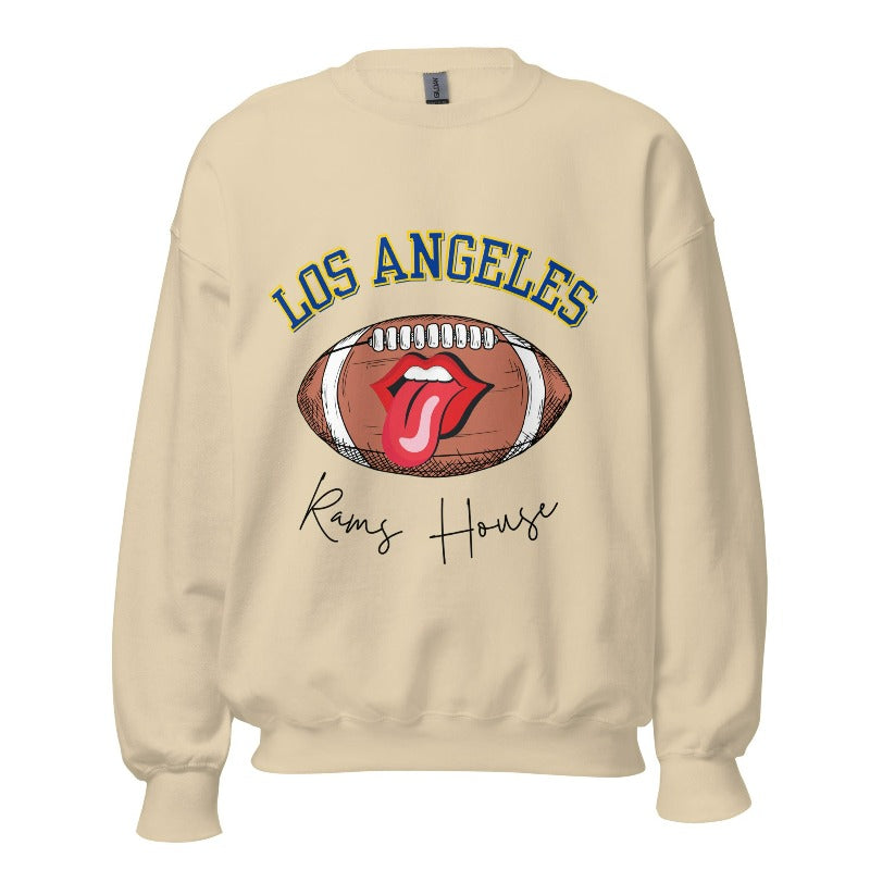 Cheer on the Los Angeles Rams in style with our exclusive sweatshirt featuring the team name and iconic slogan, "Ram House." On a sand colored sweatshirt. 