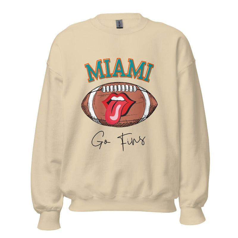Show off your Miami Dolphins pride with this eye-catching sweatshirt, boasting a football and playful lips and tongue design. Highlighted with the team's motivating slogan "Go Fins" and the iconic Miami wordmark, on a sand colored sweatshirt. 