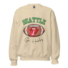 Support the Seattle Seahawks in style with this unique sweatshirt featuring a football and playful lips and tongue design. Featuring the team's slogan "Go Hawks" and the iconic Seattle wordmark, on a sand colored sweatshirt. 