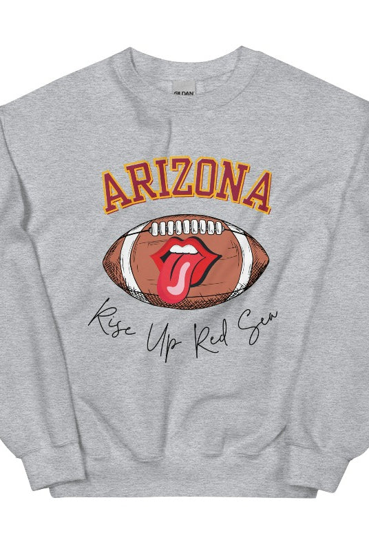 Support the Arizona Cardinals in style with our exclusive sweatshirt featuring the team's name and rallying slogan, "Rise Up Red Sea." On a sports grey sweatshirt.