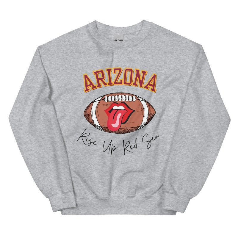 Support the Arizona Cardinals in style with our exclusive sweatshirt featuring the team's name and rallying slogan, "Rise Up Red Sea." On a sports grey sweatshirt.