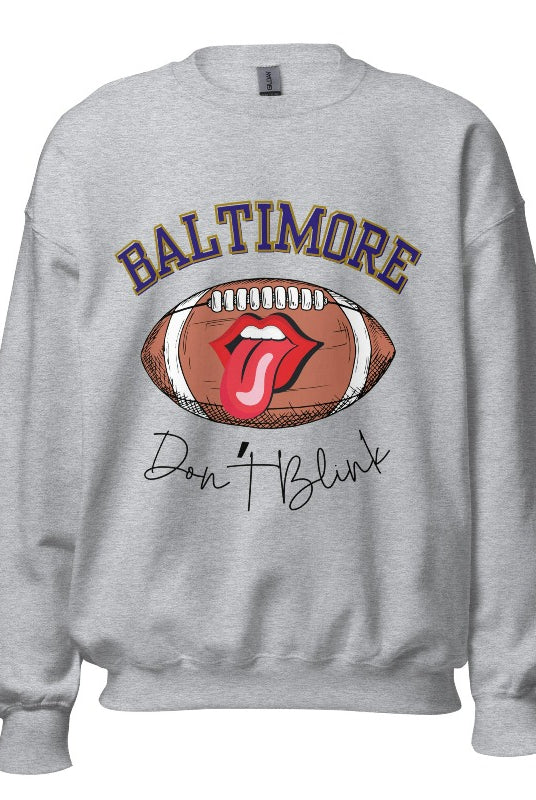 Embrace your Baltimore Ravens pride with our modern and trendy sweatshirt featuring the team's name and powerful slogan, "Don't Blink." On a sports grey sweatshirt. 