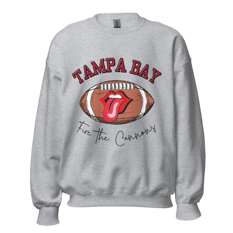 Get ready to showcase your support for the Tampa Bay Buccaneers with this eye-catching sweatshirt. Featuring a football and playful lips and tongue design, it proudly displays the team's rallying cry "Fire the Cannons" and the distinctive Tampa Bay wordmark on a sports grey sweatshirt. 