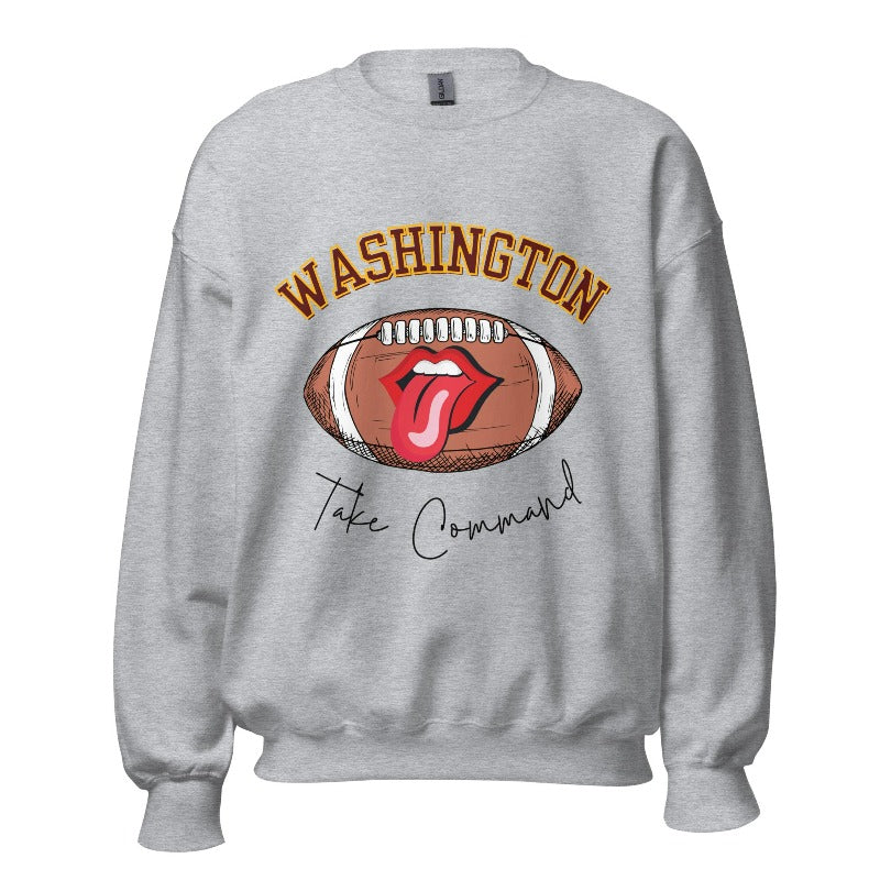 Show your support for the Washington Commanders with this stylish sweatshirt, featuring a football and fun lips and tongue design. Complete with the team's slogan "Take Command" and the distinctive Washington wordmark, on a sports grey sweatshirt. 