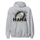 Gildan Hoodie Sweatshirt featuring a cheetah print football graphic with the word "MAMA" in bold black letters underneath, set against a dynamic black splatter background. The hoodie has a front pouch pocket, double-lined hood, and rib-knit cuffs and waistband. This design is on a grey hoodie