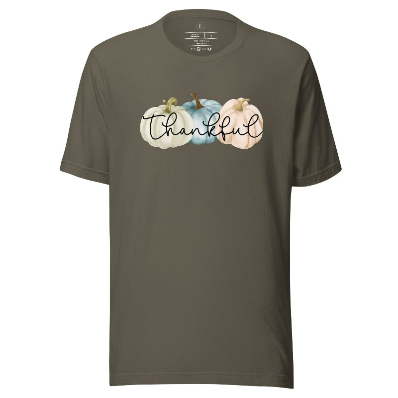 Express gratitude in style with our charming t-shirt. This design radiates autumn appreciation, featuring three pastel pumpkins and the word 'thankful' gracefully woven through the middle on an army colored shirt. 