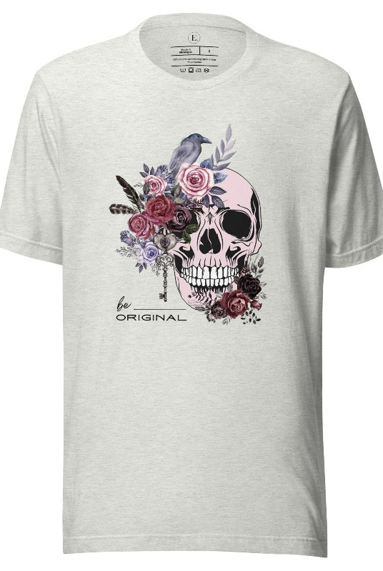 Looking for a unique Halloween shirt? Look no further! Our hauntingly beautiful shirt features a floral skull, raven, and the empowering slogan 'Be Original'. Stand out from the crowd with this unforgettable statement piece on an ash colored shirt. 