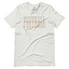 "FOOTBALL" repeated in different shades of brown and tan, with each instance of the word displayed in a slightly different style on a grey shirt.