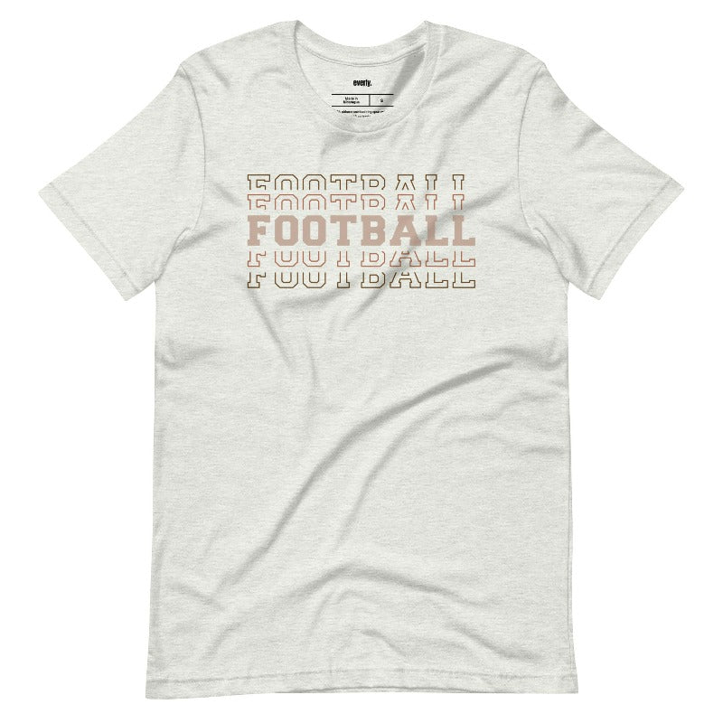 "FOOTBALL" repeated in different shades of brown and tan, with each instance of the word displayed in a slightly different style on a grey shirt.