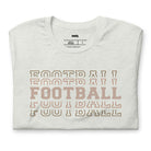 "FOOTBALL" repeated in different shades of brown and tan, with each instance of the word displayed in a slightly different style on a grey shirt.