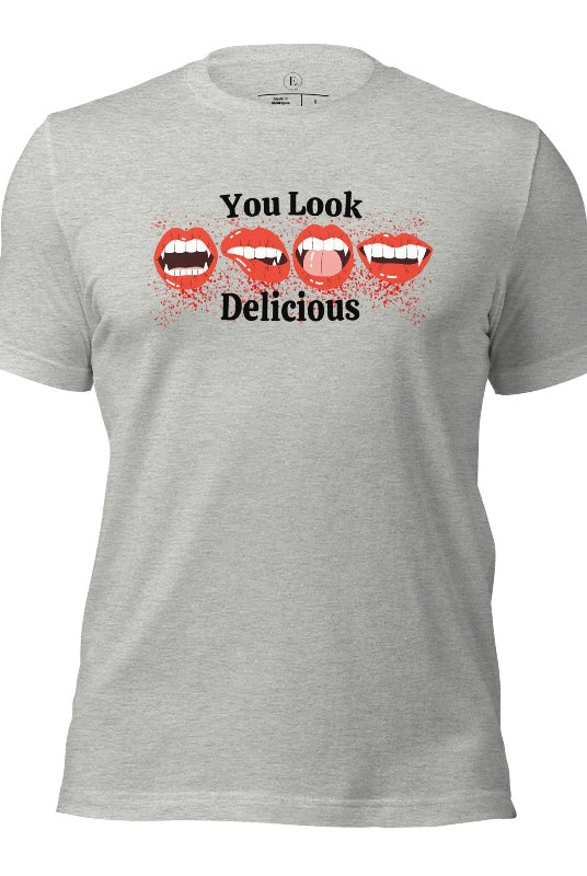 Indulge in wickedly delightful style with our vampire lips shirt. Featuring alluring lips dripping with Halloween allure, this shirt captivates with its seductive charm. The cheeky message, 'You Look Delicious,' on an athletic heather grey shirt. 