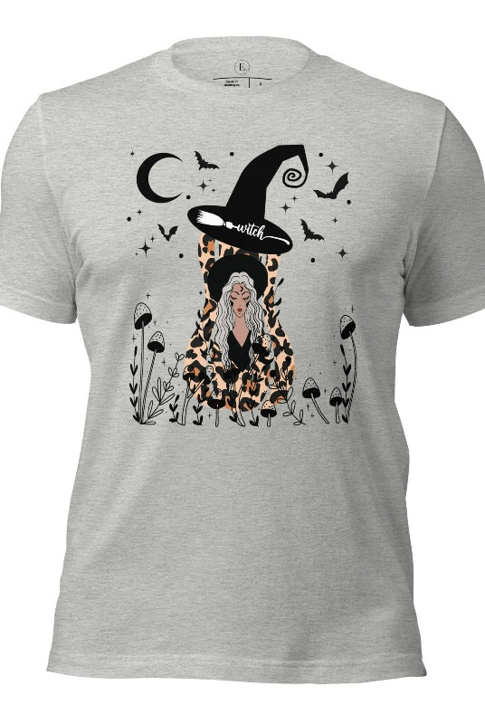Elevate your Halloween style with our striking shirt featuring a cheetah print squash and a stylish lady donning a witch hat adorned with flowers and bats. Embrace the enchanting fusion of nature and magic on an athletic heather grey shirt. 