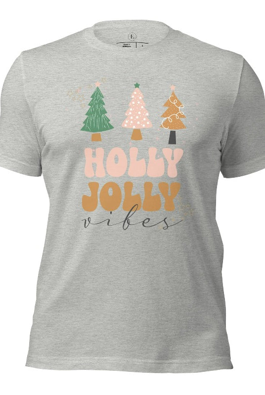 Get ready to feel the holly jolly vibes with our Christmas shirt! This festive shirt features a playful message that reads "Holly Jolly Vibes" and is adorned with cheerful Christmas trees, radiating the holiday cheer on a athletic heather grey shirt.