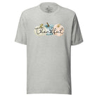 Express gratitude in style with our charming t-shirt. This design radiates autumn appreciation, featuring three pastel pumpkins and the word 'thankful' gracefully woven through the middle on an athletic heather grey shirt. 