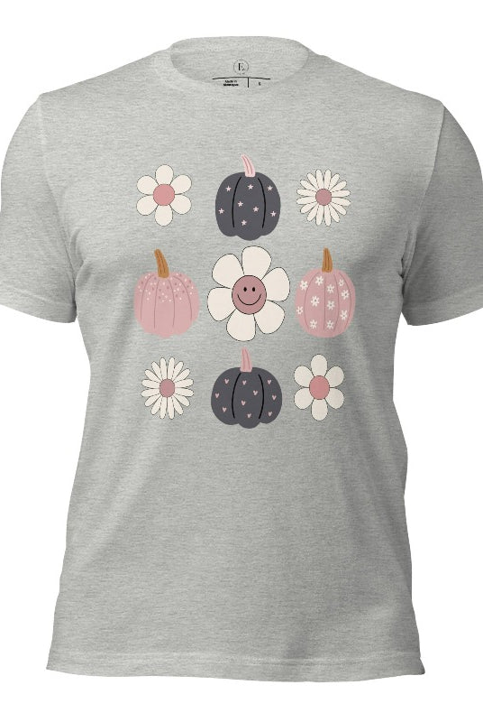Step into retro autumn vibes with our trendy t-shirt. Featuring a delightful combination of pumpkins and retro flowers, on an athletic heather grey shirt. 