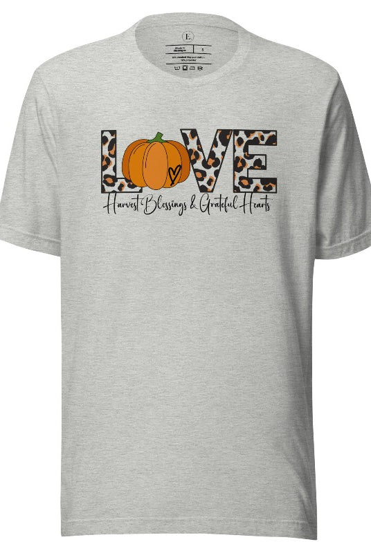 Spread love and autumn vibes with our trendy t-shirt. Featuring the word 'love' in cheetah print with a pumpkin as the 'o,' and "Harvest Blessings and Grateful Hearts' underneath on an athletic heather grey shirt. 