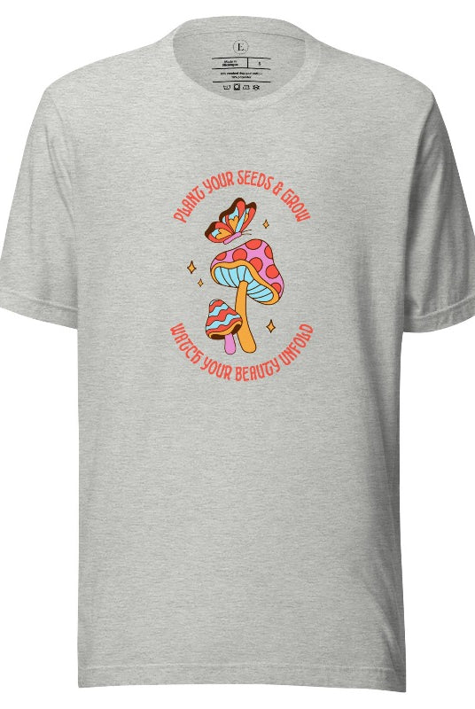 Embrace the beauty of nature with our mushroom and butterfly shirt. Featuring a captivating design of a mushroom and butterfly, it symbolizes growth and transformation. With the inspiring message "Plant your seed and grow watch your beauty unfold," on an athletic heather grey shirt. 