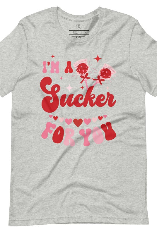 Indulge in the spirit of love with our Valentine's Day shirt! Adorned with charming Valentine lollipops and the playful saying, "I'm a sucker for you," on an athletic heather grey shirt. 