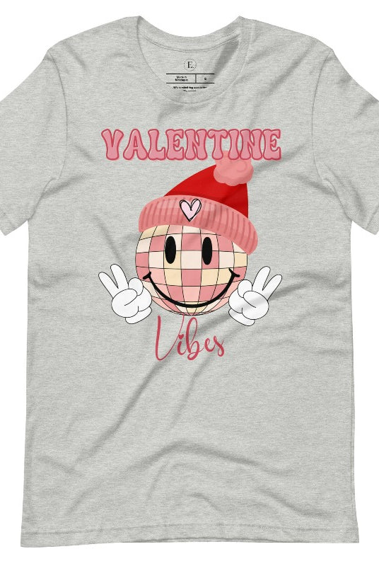 Get into the Valentine's Day spirit with our fun and funky shirt donning the words "Valentine Vibes" alongside a disco ball smiley face flashing peace fingers on an athletic heather grey shirt. 