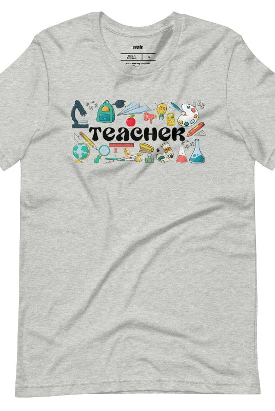 Teacher-themed graphic tee featuring the word 'Teacher' surrounded by all things related to teaching. Perfect for teacher shirts and teacher gifts. Grey graphic tees. 