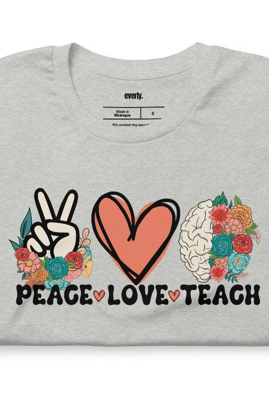 Floral design featuring the words 'peace love teach' on a teacher graphic tee - a great choice for teacher shirts and teacher gifts. Grey graphic tees. 