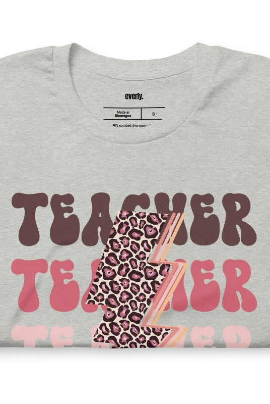 Grey teacher graphic tee with pink cheetah lightning bolt and the word 'teacher' - perfect for teacher shirts and teacher gifts. Eye-catching graphic tee for educators.
