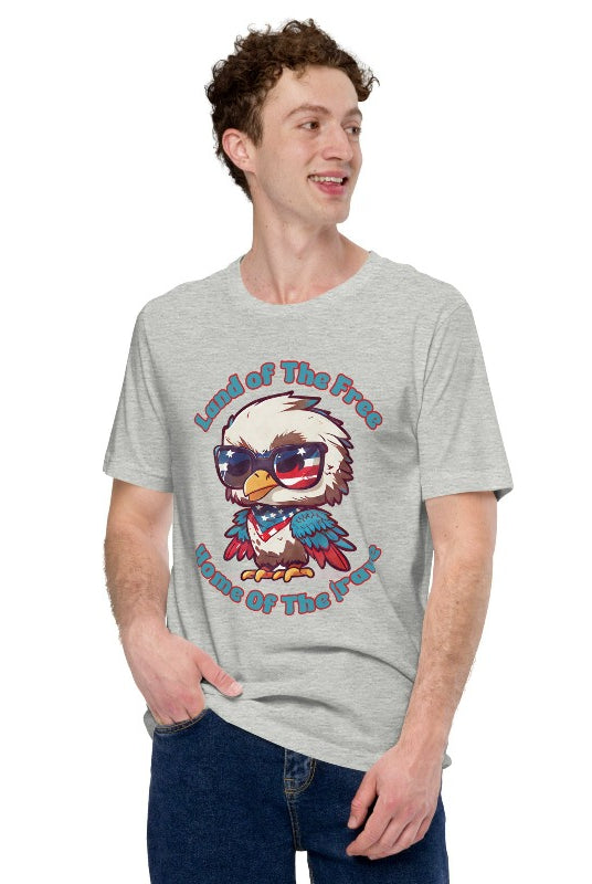 Graphic of a bird wearing sunglasses and a USA-themed scarf, with the text 'Land of the Free, Home of the Brave' on the front of an athletic heather grey graphic tee.