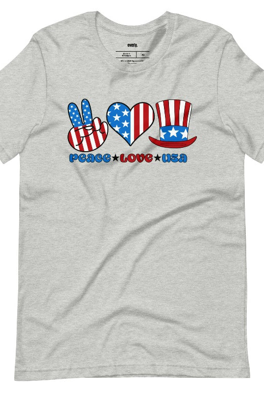 A graphic tee for the USA July 4th celebration featuring the text "peace love USA" in bold and colorful letters. The design is centered and surrounded by stars and stripes, capturing the patriotic spirit of Independence Day on an athletic heather grey graphic tee.