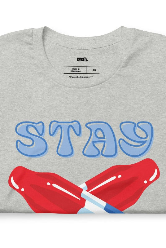 A fun and playful graphic tee for the USA July 4th celebration featuring vibrant and colorful bomb popsicles with the text 'Stay Cool' on the front. The tee captures the essence of summertime and the festive spirit of July 4th, making it a perfect choice for a cool and refreshing look on a grey graphic tee.