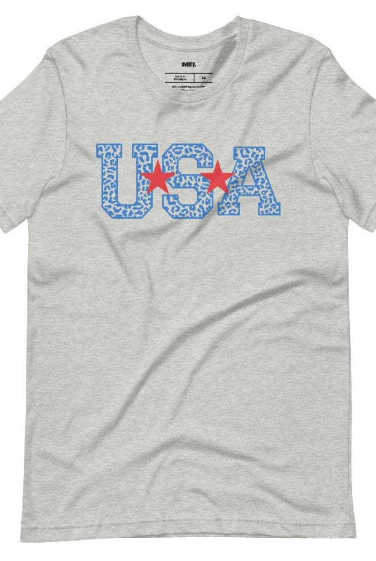 Stylish and bold USA July 4th graphic tee with blue cheetah print 'USA' on the front, adding a trendy and fierce touch to your patriotic wardrobe on a grey graphic tee.