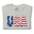 The alt text for the product photo could be: "Graphic tee featuring 'USA' with stars and stripes design, symbolizing the American flag on a grey tee - great for celebrating the Fourth of July in style.