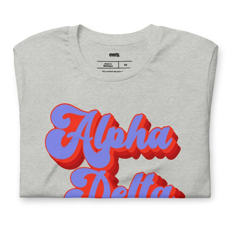 Grey graphic tee featuring 'Alpha Delta Chi' in retro lettering