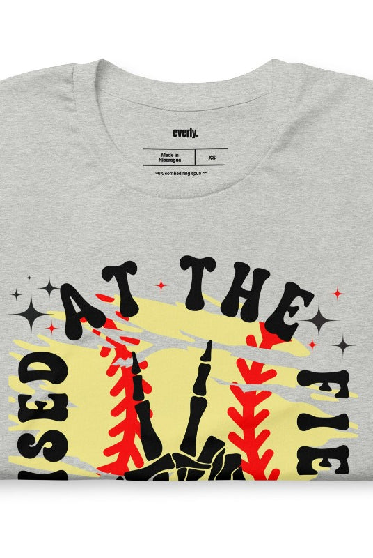 Raised at the field softball retro design on a grey graphic tee.