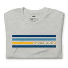 Bella + Canvas 3001 unisex t-shirt featuring bold blue and gold horizontal stripes with the word "CALIFORNIA" prominently displayed in the center on a grey shirt