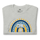 Bella + Canvas 3001 unisex t-shirt featuring a playful blue and gold rainbow design with "CAL" in the center, surrounded by hearts and dots on a grey graphic tee.