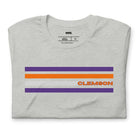 Bella + Canvas 3001 unisex T-shirt featuring a Clemson University design with purple, orange, and grey stripes and the word "Clemson" in bold orange letters on a grey shirt