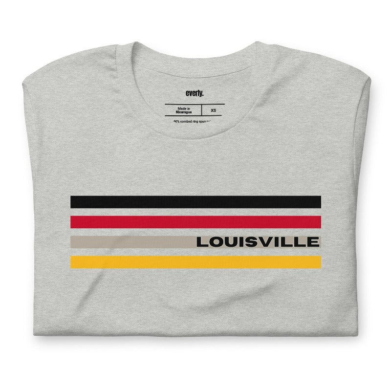 A Bella + Canvas 3001 unisex t-shirt featuring stylish stripes in black, red, and gold with "Louisville" text, perfect for University of Louisville fans, made of 100% combed and ring-spun cotton on a grey shirt.