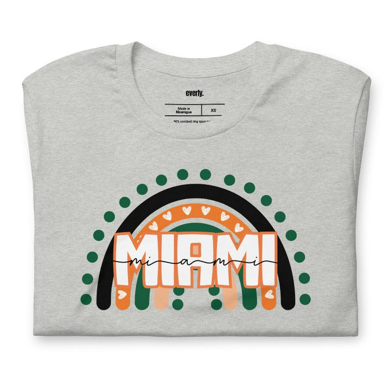 Bella + Canvas 3001 unisex shirt featuring a rainbow design in orange, green, and black with "Miami" text and decorative hearts and dots on a grey shirt.