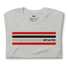 Bold red, black, and grey stripes with "STATE" text for NC State on a grey shirt.